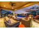 This patio and pool area features a seating area and a fire pit at 9059 E Leonora St. St, Mesa, AZ 85207