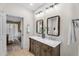 Bright bathroom with a double vanity and doorway to the bedroom at 9223 E Camino Del Santo --, Scottsdale, AZ 85260