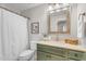 Bathroom with a decorative mirror, cream countertops and a green vanity and neutral paint at 9223 E Camino Del Santo --, Scottsdale, AZ 85260
