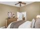 Cozy bedroom with neutral tones, wood dresser, and a doorway to the ensuite bathroom at 9223 E Camino Del Santo --, Scottsdale, AZ 85260