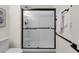Modern bathroom shower featuring white subway tile and sleek black hardware at 9707 W Lancaster Dr, Sun City, AZ 85351
