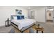 Serene bedroom with plush bedding, stylish side tables, and ample natural light at 9707 W Lancaster Dr, Sun City, AZ 85351