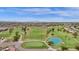 Expansive aerial view of the golf course, pond, and surrounding homes in a vibrant community at 9707 W Lancaster Dr, Sun City, AZ 85351