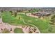 Lush green golf course in a residential community, featuring mature trees and walking paths at 9707 W Lancaster Dr, Sun City, AZ 85351