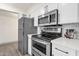 Updated kitchen with stainless steel appliances, sleek countertops and white cabinetry at 9707 W Lancaster Dr, Sun City, AZ 85351