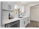 Updated kitchen featuring white cabinets, subway tile backsplash and stainless steel appliances at 9707 W Lancaster Dr, Sun City, AZ 85351