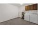 Functional laundry area features modern washer and dryer, storage, and utility hookups at 9707 W Lancaster Dr, Sun City, AZ 85351