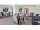 Open living room with stylish decor and tile flooring flows into the dining area at 9707 W Lancaster Dr, Sun City, AZ 85351