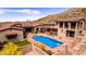 Stunning aerial view of a desert home featuring a private pool, patio, and lush desert landscaping at 9820 E Thompson Peak Pkwy # 628, Scottsdale, AZ 85255