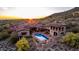 Aerial view of a home showing the pool, outdoor space, and sunset in the background at 9820 E Thompson Peak Pkwy # 628, Scottsdale, AZ 85255