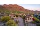 Stunning aerial view of a house with tile roof nestled in the mountains with golf course views at 9820 E Thompson Peak Pkwy # 628, Scottsdale, AZ 85255