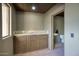 Bar area with a granite countertop, custom wood cabinets, and a view into the bathroom at 9820 E Thompson Peak Pkwy # 628, Scottsdale, AZ 85255