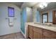 Bathroom featuring a glass shower enclosure, light wood cabinets, and neutral tiling at 9820 E Thompson Peak Pkwy # 628, Scottsdale, AZ 85255