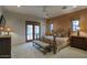 Serene bedroom with a wrought iron bed, neutral color palette, and private access to an outdoor courtyard for relaxation at 9820 E Thompson Peak Pkwy # 628, Scottsdale, AZ 85255