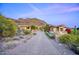 Desert landscape and mountain views enhance this desert home with its patterned brick driveway and charming desert shrubs at 9820 E Thompson Peak Pkwy # 628, Scottsdale, AZ 85255