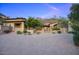 Charming desert home with mature trees, desert landscaping, and paved driveway, creating inviting curb appeal at 9820 E Thompson Peak Pkwy # 628, Scottsdale, AZ 85255