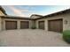 Spacious three-car garage with wooden doors and brick driveway at 9820 E Thompson Peak Pkwy # 628, Scottsdale, AZ 85255