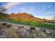 Scenic view of a golf course surrounded by desert landscape and majestic mountains at 9820 E Thompson Peak Pkwy # 628, Scottsdale, AZ 85255