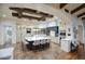 Open kitchen features a large island with seating, white countertops, cabinets, and pendant lighting, and a beautiful beamed ceiling at 9820 E Thompson Peak Pkwy # 628, Scottsdale, AZ 85255