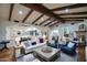 Open living room with wood beams, hardwood floors, fireplace, and plenty of space for entertaining at 9820 E Thompson Peak Pkwy # 628, Scottsdale, AZ 85255