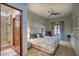 Comfortable main bedroom featuring a king bed, ceiling fan, neutral decor, and an ensuite bathroom with a glass shower at 9820 E Thompson Peak Pkwy # 628, Scottsdale, AZ 85255