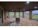 Outdoor patio with a fireplace, a ceiling fan, and a scenic golf course view at 9820 E Thompson Peak Pkwy # 628, Scottsdale, AZ 85255