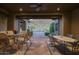 Covered patio with tiled floors, ceiling fan, mountain views, and outdoor dining furniture at 9820 E Thompson Peak Pkwy # 628, Scottsdale, AZ 85255