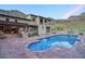 Beautiful pool with travertine tile and grassy area with a view of the home at 9820 E Thompson Peak Pkwy # 628, Scottsdale, AZ 85255