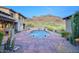 Outdoor pool area featuring a sparkling pool, desert landscaping, and a mountain backdrop at 9820 E Thompson Peak Pkwy # 628, Scottsdale, AZ 85255