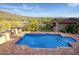 An aerial view of a private swimming pool with a patio area, landscaping, and mountain views at 9820 E Thompson Peak Pkwy # 628, Scottsdale, AZ 85255