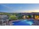 Inviting backyard pool area with brick patio and lush desert landscape at sunset at 9820 E Thompson Peak Pkwy # 628, Scottsdale, AZ 85255