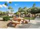 Community grilling area with picnic table and barbecue grill, set with palm trees at 10030 W Indian School Rd # 165, Phoenix, AZ 85037