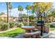 Community grilling area with picnic table and barbecue grill under palm trees at 10030 W Indian School Rd # 165, Phoenix, AZ 85037