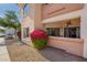 Attractive exterior of the building with landscaped gravel beds and pink flowers at 10030 W Indian School Rd # 165, Phoenix, AZ 85037