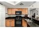 Well-equipped kitchen featuring black appliances and granite countertops at 10030 W Indian School Rd # 165, Phoenix, AZ 85037