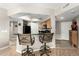 Charming kitchen with breakfast bar, sleek black appliances, wood cabinets, and recessed lighting at 10030 W Indian School Rd # 165, Phoenix, AZ 85037