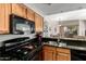 Updated kitchen featuring granite countertops and stainless-steel appliances at 10030 W Indian School Rd # 165, Phoenix, AZ 85037