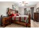 Bright main bedroom featuring rustic wood furniture, stylish ceiling fan and natural light at 10030 W Indian School Rd # 165, Phoenix, AZ 85037