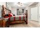 Bright main bedroom featuring rustic wood furniture, stylish ceiling fan and natural light at 10030 W Indian School Rd # 165, Phoenix, AZ 85037