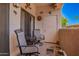 Cozy outdoor patio with seating, rug, and decorative wall art at 10030 W Indian School Rd # 165, Phoenix, AZ 85037
