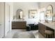 This modern bathroom features a double vanity, freestanding soaking tub, accent lighting, and a patterned rug at 10795 E Sutherland Way, Scottsdale, AZ 85262