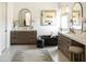 Bright bathroom featuring modern double vanity, soaking tub, a stylish rug, and a soothing ambiance at 10795 E Sutherland Way, Scottsdale, AZ 85262