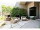 Stylish outdoor courtyard with comfortable woven chairs, plants, and modern design elements at 10795 E Sutherland Way, Scottsdale, AZ 85262