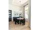 Dining nook area with modern shelving and furniture near a large window with natural light at 10795 E Sutherland Way, Scottsdale, AZ 85262