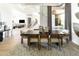 Dining area with a large table, modern lighting, and an open floor plan at 10795 E Sutherland Way, Scottsdale, AZ 85262