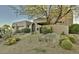Southwest style home featuring lush desert landscaping and a rock garden at the entrance with cactus at 10795 E Sutherland Way, Scottsdale, AZ 85262