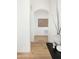Hallway featuring wood floors and arched doorways at 10795 E Sutherland Way, Scottsdale, AZ 85262