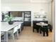 Kitchen area with a large island, stylish lighting, and a dining nook with a bar at 10795 E Sutherland Way, Scottsdale, AZ 85262