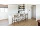 Bright kitchen with modern white countertops, light wood flooring, and a stylish shelving unit at 10795 E Sutherland Way, Scottsdale, AZ 85262