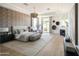 This spacious main bedroom offers a cozy seating area, fireplace, patterned accent wall, and a calming color palette at 10795 E Sutherland Way, Scottsdale, AZ 85262